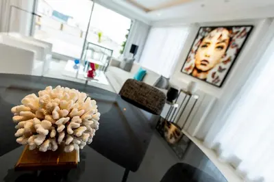 a living room with a glass table with a bowl on it at The RoofTop by Connexion in Cannes