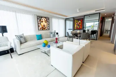 a living room with a white couch and a table at The RoofTop by Connexion in Cannes