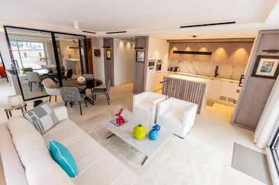 a living room with a white couch and a table at The RoofTop by Connexion in Cannes