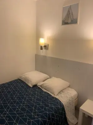 a room with a bed with two pillows on it at Bord de mer et commerces 588 in Cannes