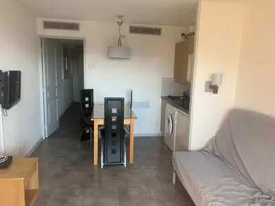 a small living room with a table and a couch at Bord de mer et commerces 588 in Cannes