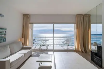 a living room with a couch and a view of the ocean at Beautiful studio with great sea view in Cannes