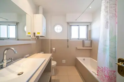 a bathroom with a tub and a sink and a toilet at Beautiful studio with great sea view in Cannes