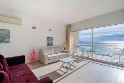 a living room with a couch and a view of the ocean at Beautiful studio with great sea view in Cannes