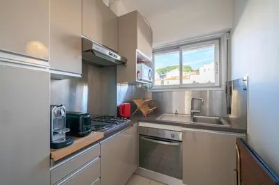 a small kitchen with a sink and a window at Beautiful studio with great sea view in Cannes
