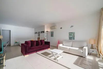 a living room with a couch and a table at Beautiful studio with great sea view in Cannes