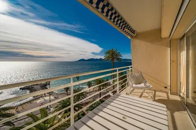 a balcony with a bench and a view of the ocean at Beautiful studio with great sea view in Cannes