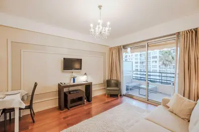 a living room with a couch and a table and a television at Wdf studio right in the heart of Cannes!! in Cannes