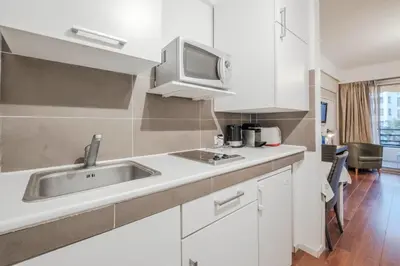 a kitchen with a sink and a microwave at Wdf studio right in the heart of Cannes!! in Cannes