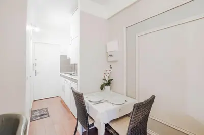 a white dining room with a white table and chairs at Wdf studio right in the heart of Cannes!! in Cannes