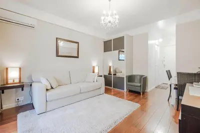 a living room with a white couch and a table at Wdf studio right in the heart of Cannes!! in Cannes