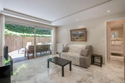 a living room with a couch and a table at Wdf one bedroom heart of Cannes in Cannes