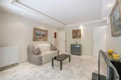 a living room with a couch and a tv at Wdf one bedroom heart of Cannes in Cannes