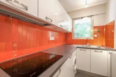 an orange and white kitchen with a sink and a window at Wdf one bedroom heart of Cannes in Cannes