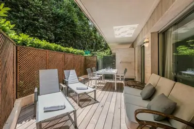 a patio with a couch and tables and chairs at Wdf one bedroom heart of Cannes in Cannes