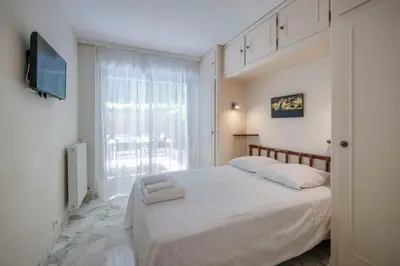 a bedroom with a white bed and a window at Wdf one bedroom heart of Cannes in Cannes