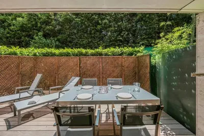 a white table and chairs on a patio at Wdf one bedroom heart of Cannes in Cannes