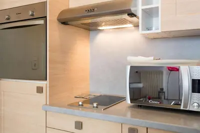 a kitchen with a microwave on a counter at Cannes Croisette Studio 3 pers Cosy CLIM WIFI PKG in Cannes
