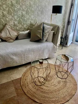 a living room with a couch with two tables at Cannes Croisette Studio 3 pers Cosy CLIM WIFI PKG in Cannes