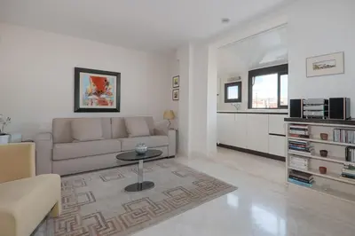 a living room with a couch and a table at Wonderful studio heart of Cannes!! in Cannes