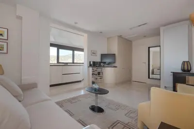 a living room with a white couch and a table at Wonderful studio heart of Cannes!! in Cannes