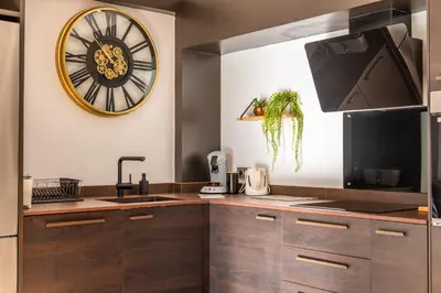 a kitchen with a large clock on the wall at Bright 2bedroom apartment 15min walk to the Palais in Cannes