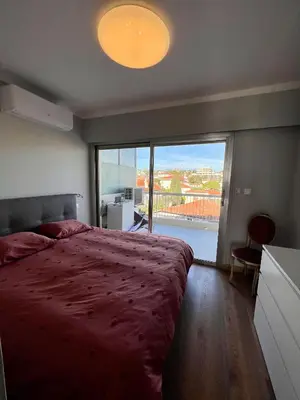 a bedroom with a large bed and a large window at Cannes Santa Catalina in Cannes