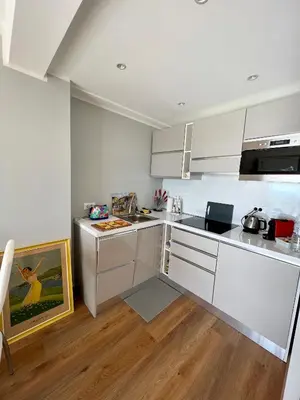 a kitchen with white cabinets and a counter top at Cannes Santa Catalina in Cannes