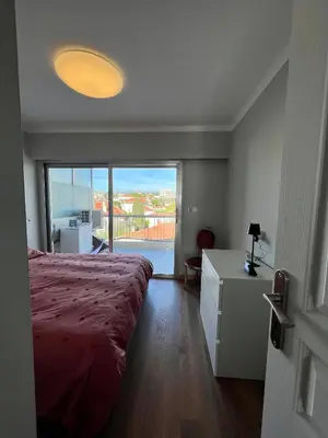 a bedroom with a large bed and a large window at Cannes Santa Catalina in Cannes
