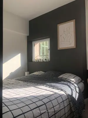 a bedroom with a bed and a window at Studio cosy en plein centre-ville in Cannes