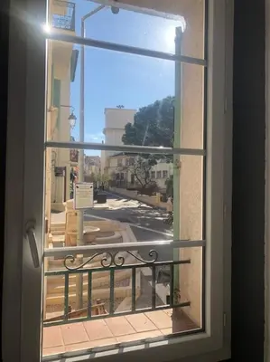 a window with a view of a city street at Studio cosy en plein centre-ville in Cannes