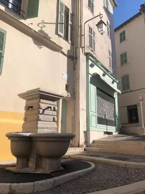 a stone fountain in the middle of a street at Studio cosy en plein centre-ville in Cannes