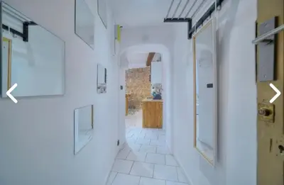 a hallway with white walls and an open door at Appartement Canne 1 chambre - 12RP in Cannes