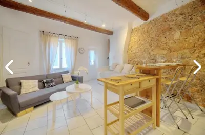 a living room with a couch and a table at Appartement Canne 1 chambre - 12RP in Cannes
