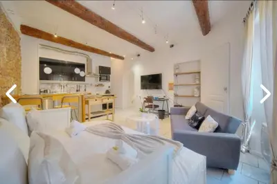 a living room with a couch and a kitchen at Appartement Canne 1 chambre - 12RP in Cannes
