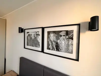 three framed pictures on a wall in a room at Appartement comme une suite d’hôtel in Cannes