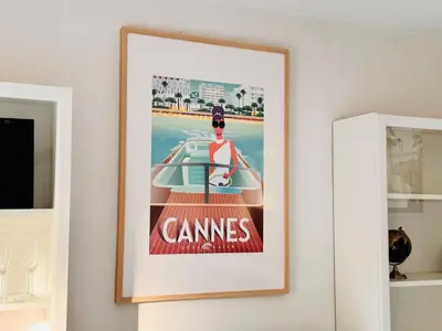a framed picture of a man on a boat at Le Jardin Gallieni - Terrasse Cozy in Cannes