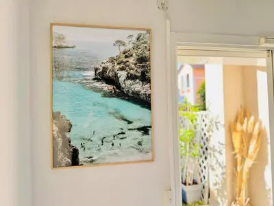 a picture of a beach on a wall at Le Jardin Gallieni - Terrasse Cozy in Cannes