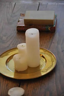 two candles on a gold plate on a table at Terrasse Vue Mer - A quelques minutes de Cannes in Le Cannet