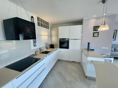 a living room with a couch and a television at Le President II by Connexion in Cannes