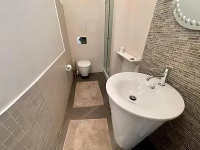 a kitchen with a table and a couch in a room at Le President II by Connexion in Cannes