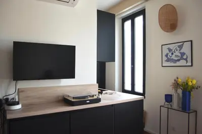 a living room with a flat screen tv on a wall at T2 Cannes centre in Cannes