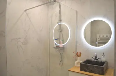 a bathroom with a shower with a sink and a mirror at T2 Cannes centre in Cannes