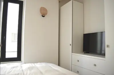 a bedroom with a flat screen tv and a bed at T2 Cannes centre in Cannes