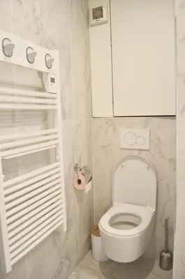 a bathroom with a toilet and a white cabinet at T2 Cannes centre in Cannes