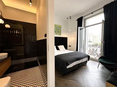 a bedroom with a bed and a large window at Luxury Cannes in Cannes