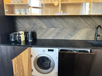 a kitchen with a washing machine under a counter at Luxury Cannes in Cannes