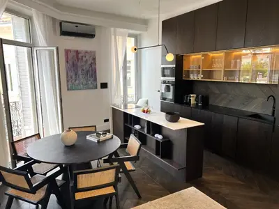 a kitchen with a table and chairs in a room at Luxury Cannes in Cannes