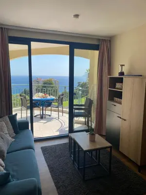 a living room with a couch and a view of the ocean at Cannes vue mer appt 4pers in Cannes