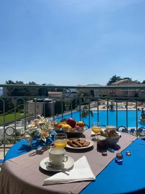 a table with food and drinks on top of a balcony at Cannes vue mer appt 4pers in Cannes